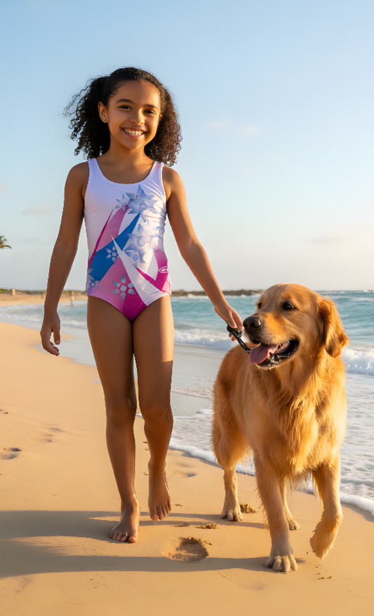 Girl in a swimsuit walking a dog on a beach with palm trees in the background